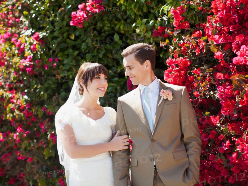 Bride and groom strolling in garden. Photo: Jessica Peterson