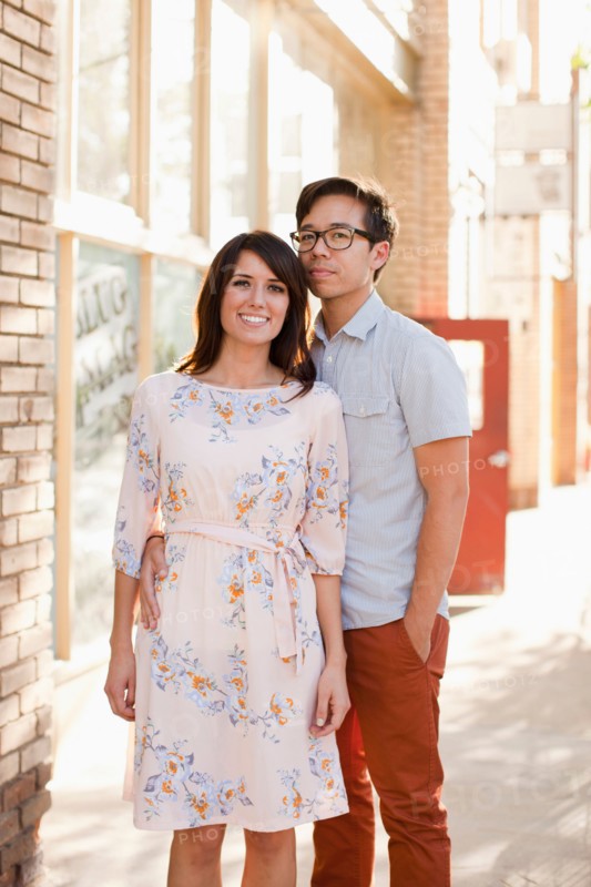 Portrait of couple standing on sidewalk. Photo : Jessica Peterson
