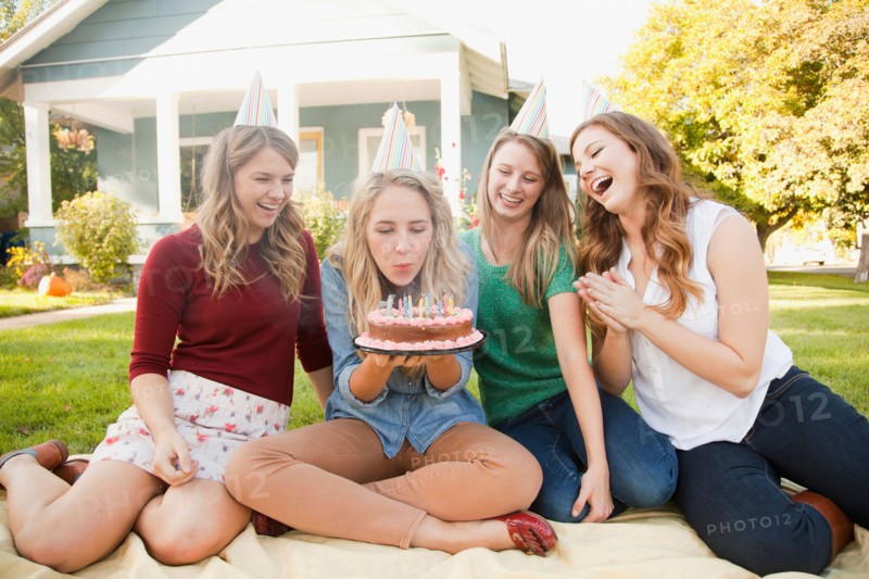 Young woman celebrating her birthday with friends. Photo: Jessica Peterson