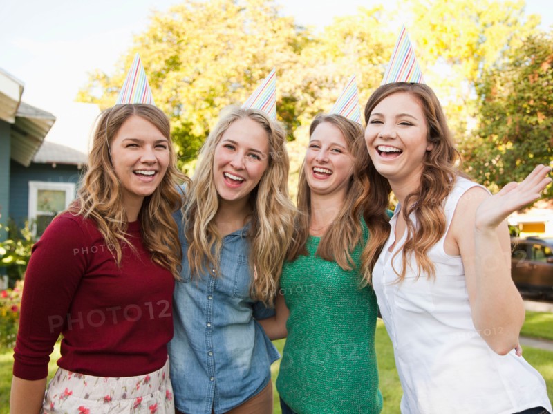 Portrait of four friends wearing party hat. Photo : Jessica Peterson