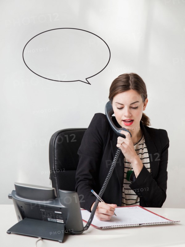 Studio shot of young woman talking on phone with speech bubble next to her head. Photo: Jessica Peterson