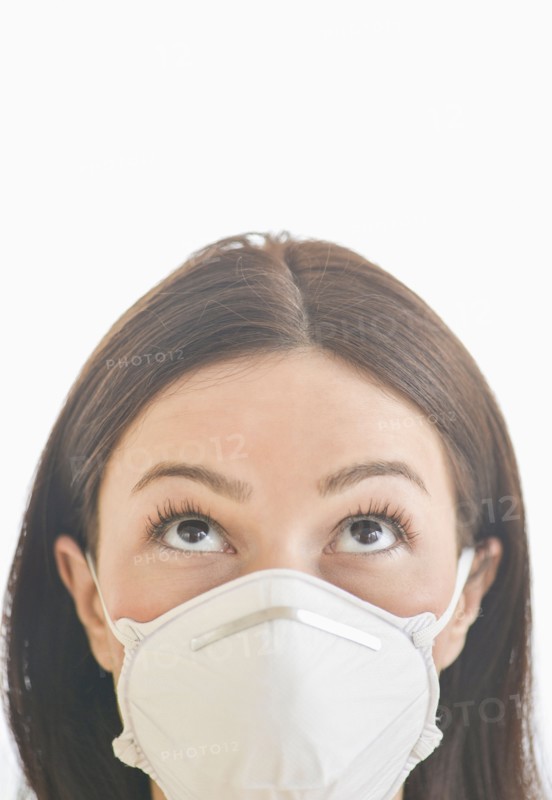 Studio portrait of woman wearing flu mask.