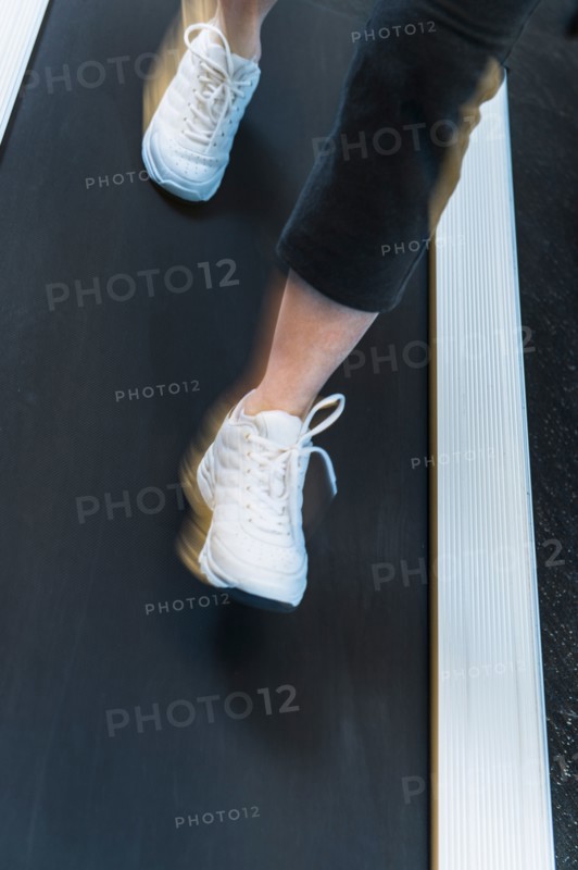 Low section of woman on treadmill.