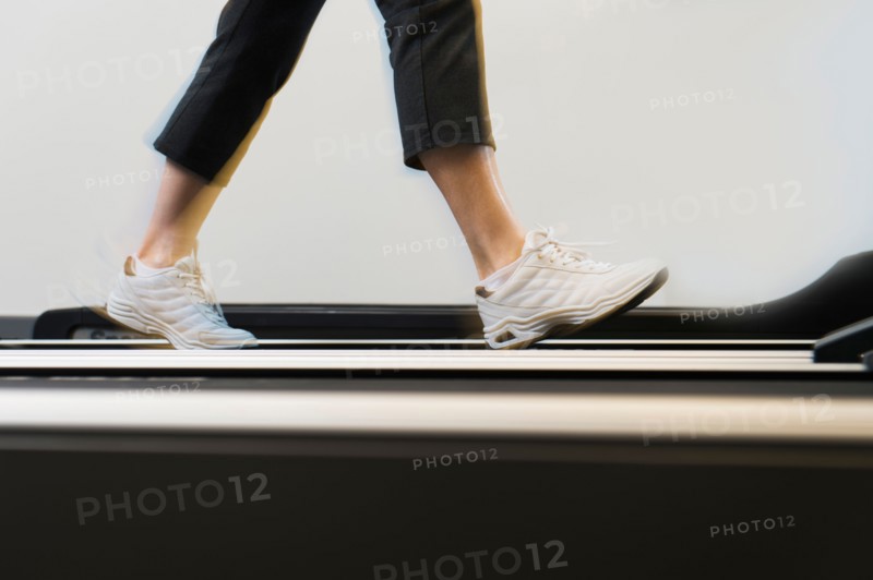 Low section of woman on treadmill.