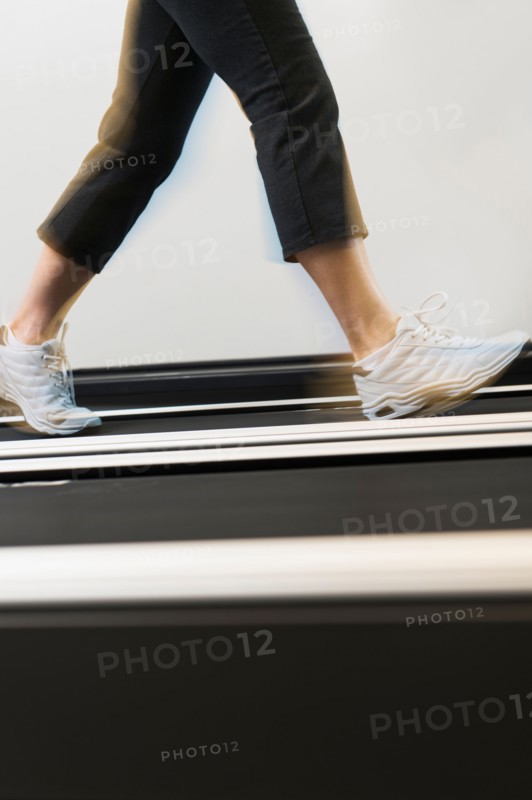 Low section of woman on treadmill.