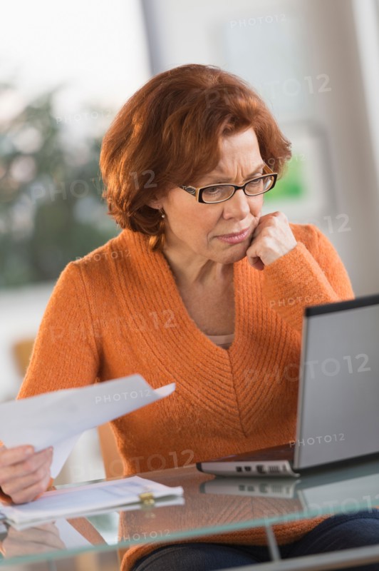 Senior woman working on laptop at home.