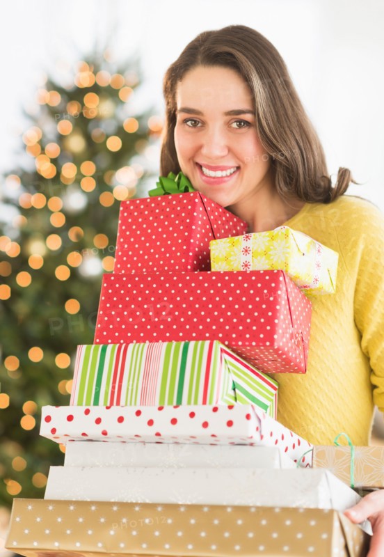 Woman holding christmas gifts.