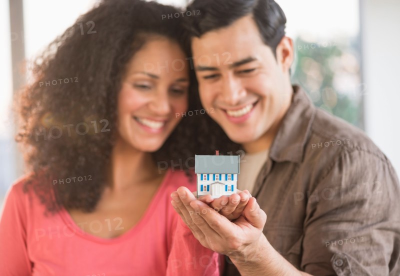 Smiling couple with model home.