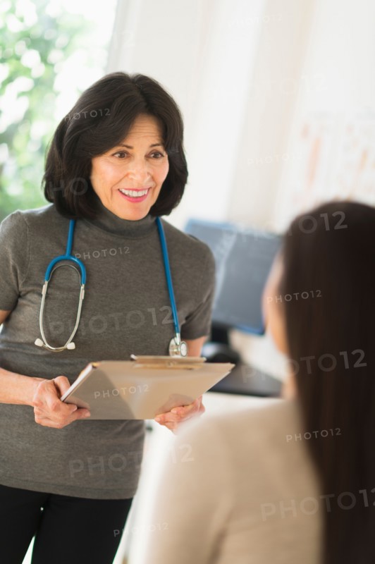 Doctor talking to teenage girl (16-17).