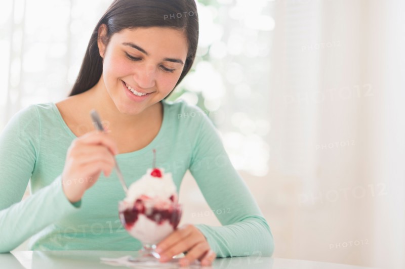 Teenage girl (16-17) eating ice-cream.