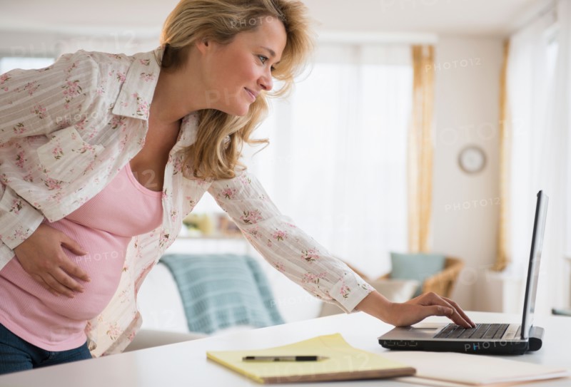 Pregnant woman using laptop