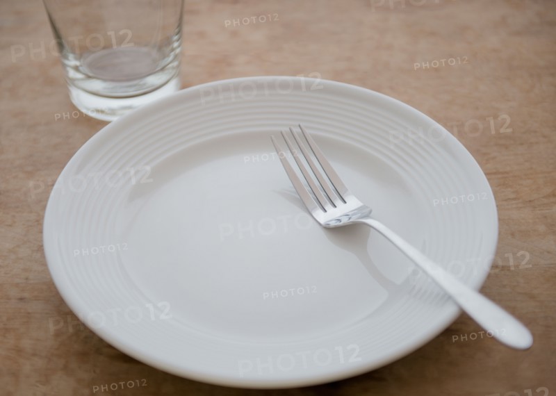 White plate with fork and glass