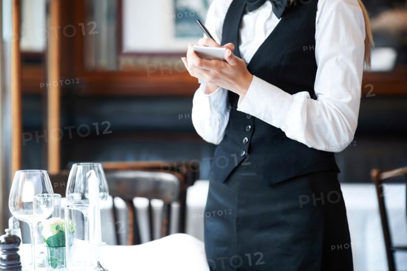 Young waitress taking order