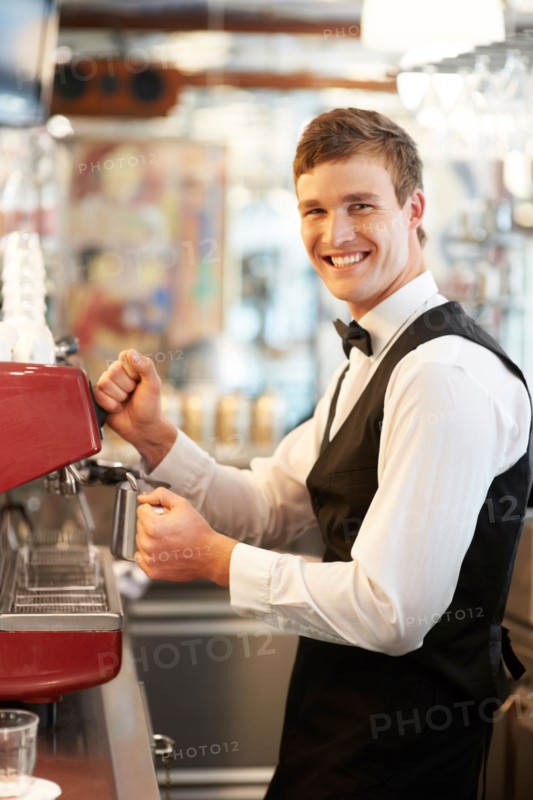 Portrait of barista standing by coffee maker