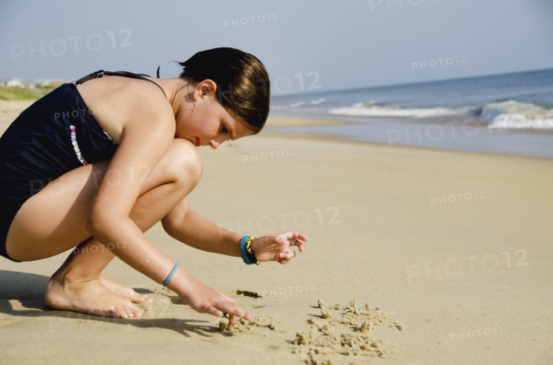 Girl (8-9) playing at beach