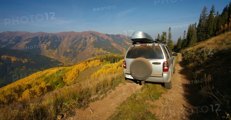 Mountain landscape with car on dirt road