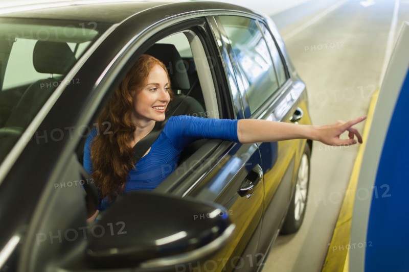 Young woman parking car