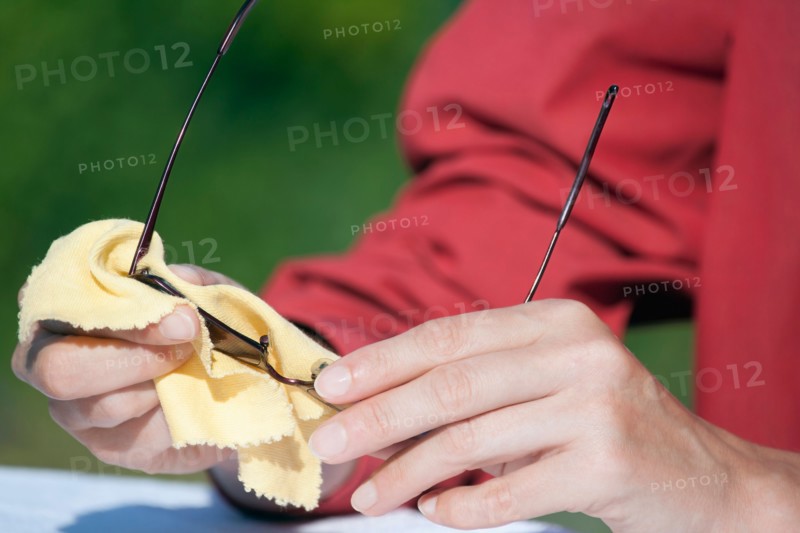 Woman cleaning sunglasses
