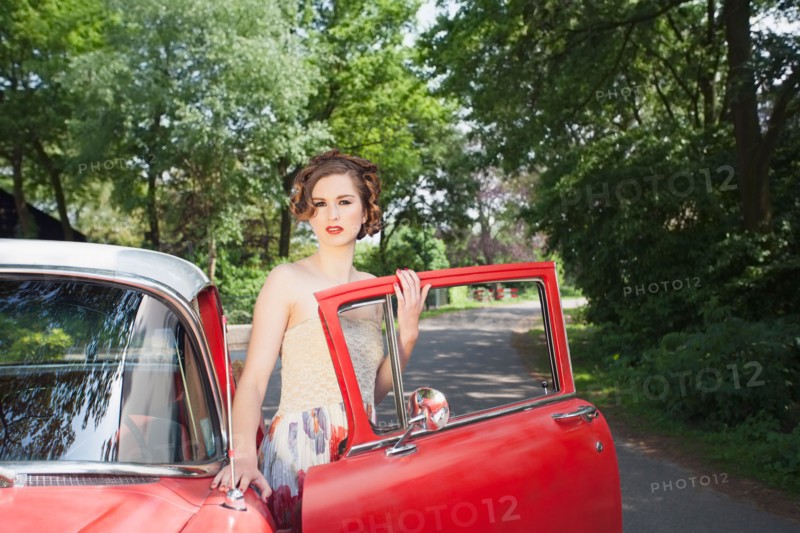 Portrait of elegant woman next to vintage car