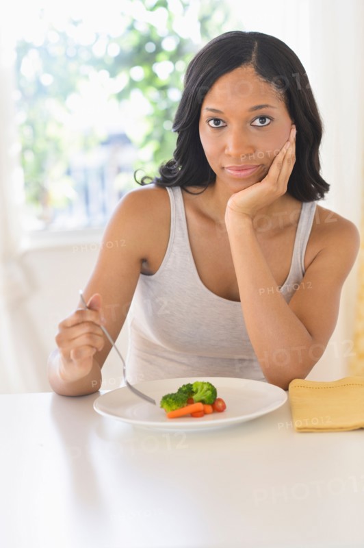Woman eating vegetables.