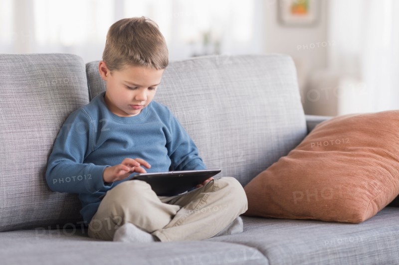 Boy (4-5) using tablet pc.