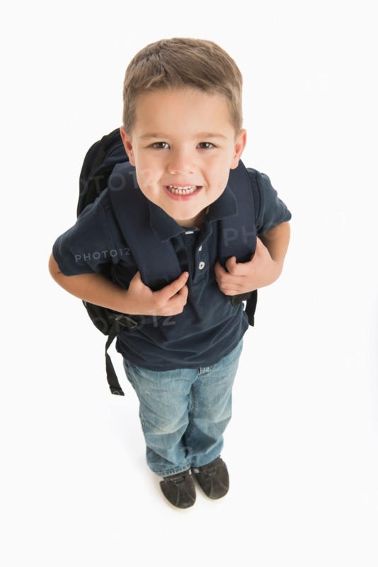 Portrait of schoolboy (4-5) carrying backpack.