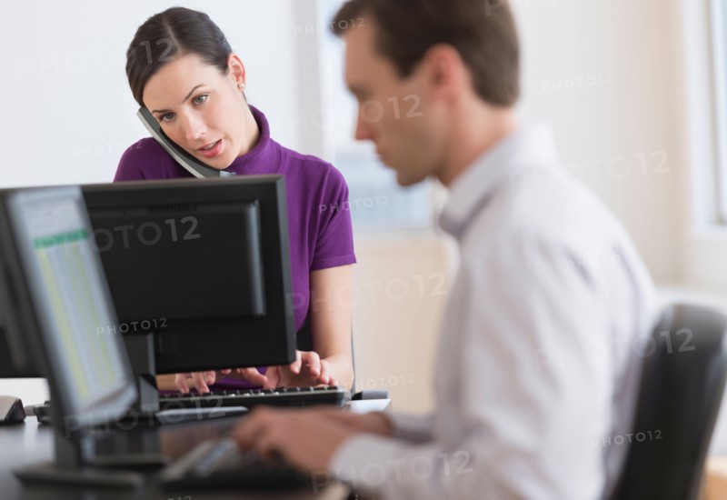 Office workers using computers.