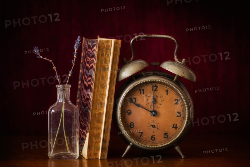 Still life with antique clock and books.