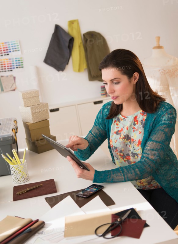 Fashion designer using digital tablet.