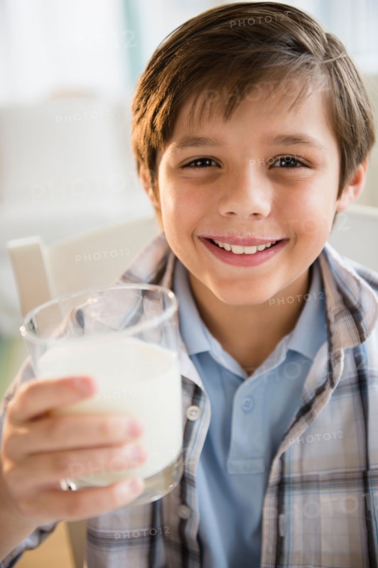 Boy (8-9) drinking milk