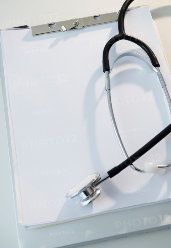 Studio shot of stethoscope and clipboard with blank paper