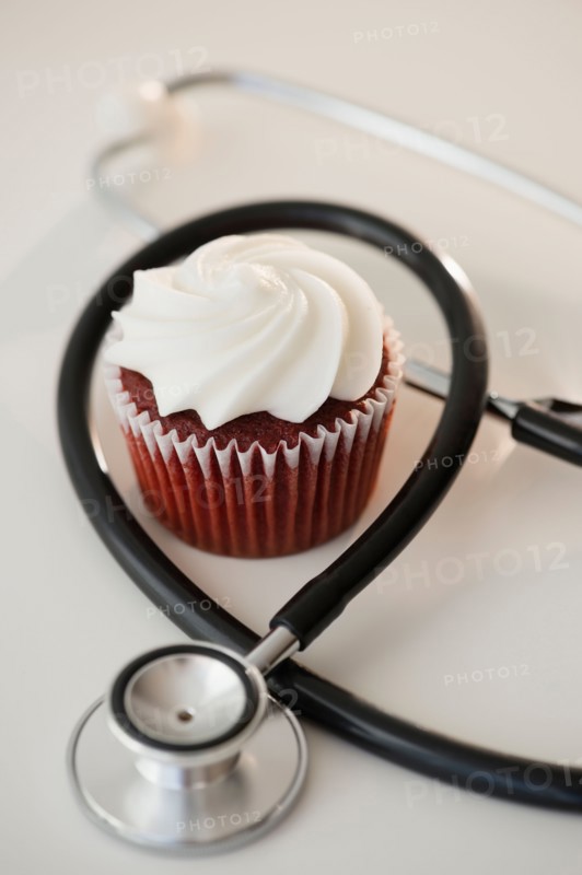 Studio shot of stethoscope and cupcake