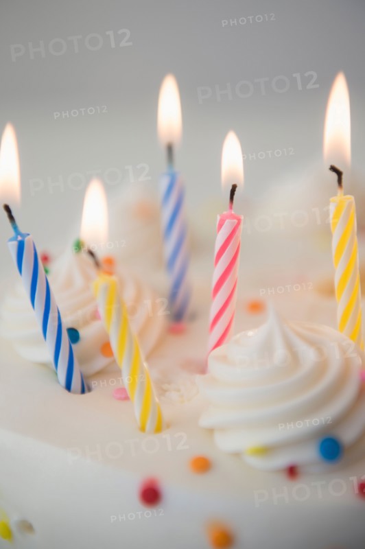 Studio shot of birthday cake with lit candles