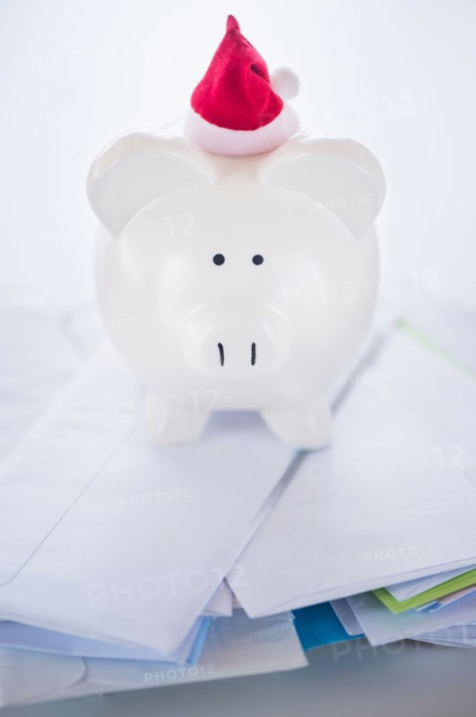 Still life with Santa piggy bank and bills