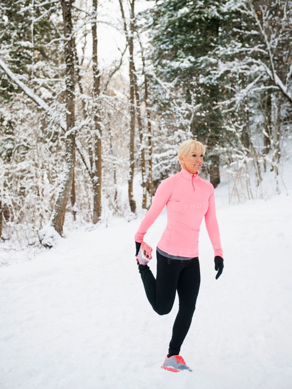 Woman exercising in winter forest