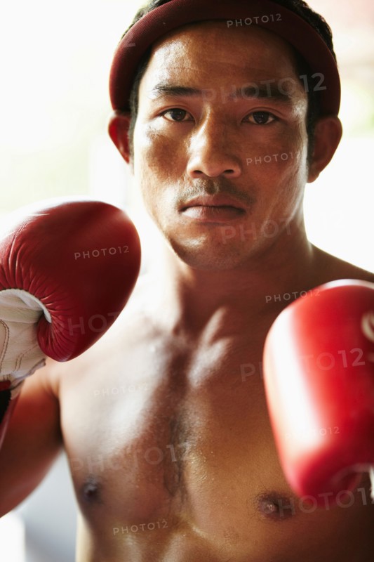 Portrait of mid adult male boxer in fighting stance