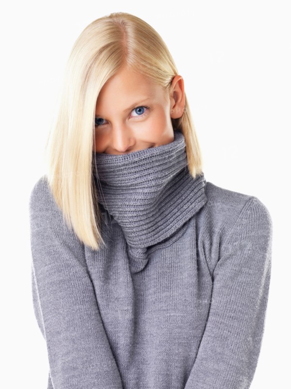 Studio portrait of young woman wearing gray sweater