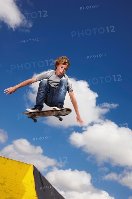 Young man on skateboard jumping