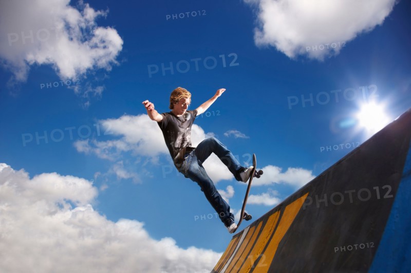 Young man on skateboard jumping