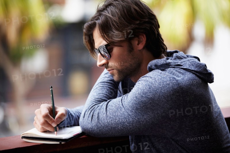 Man in sunglasses writing dirty