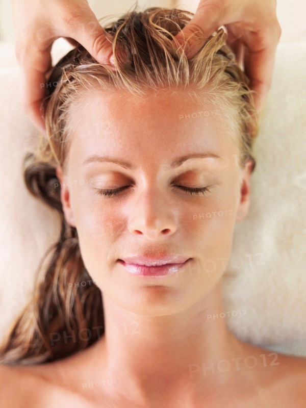 Mid adult woman receiving head massage