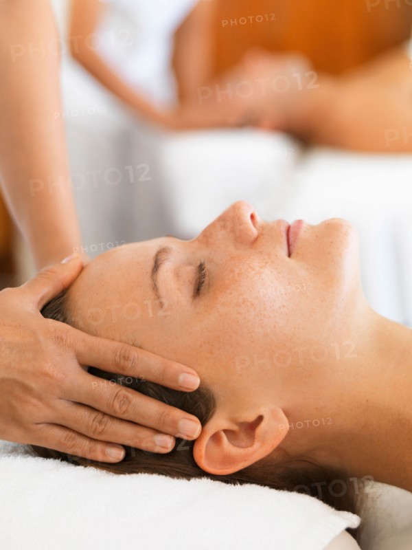 Two people getting massage in spa