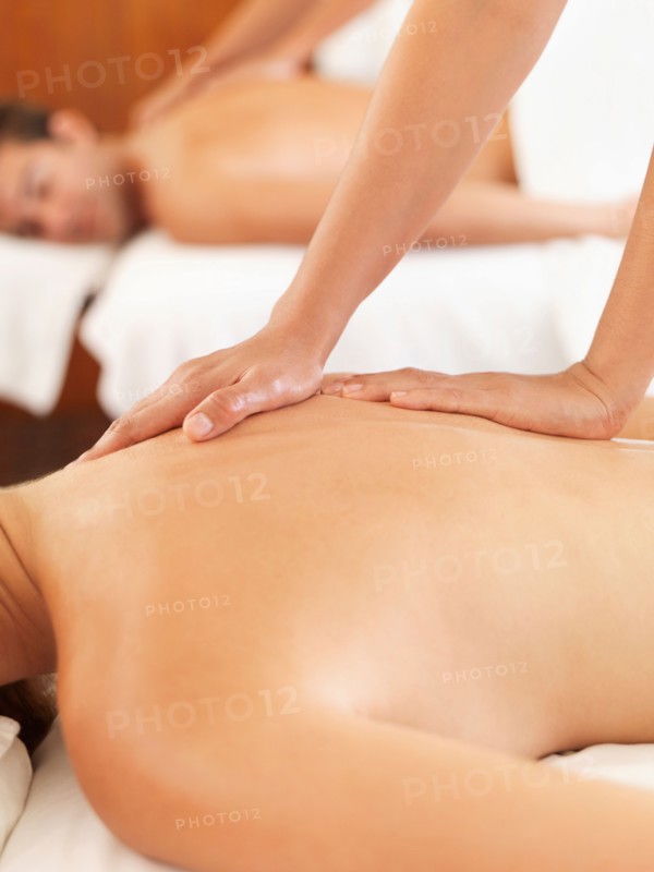 Two people getting massage in spa