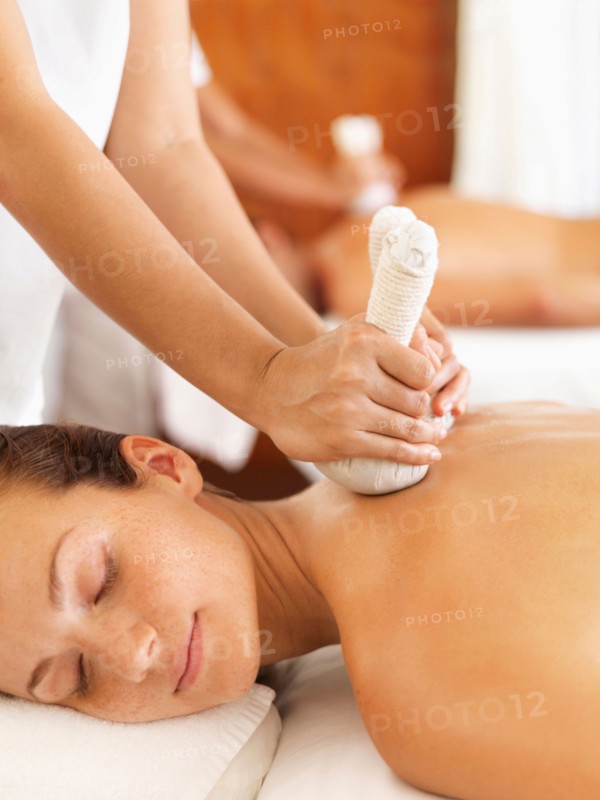 Two people getting massage in spa
