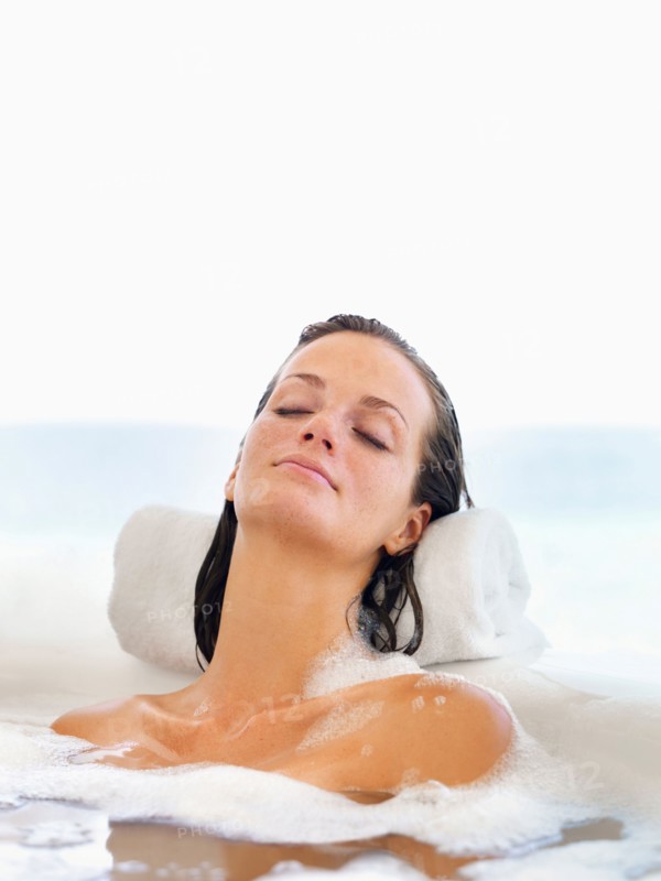 Woman relaxing in bathtub