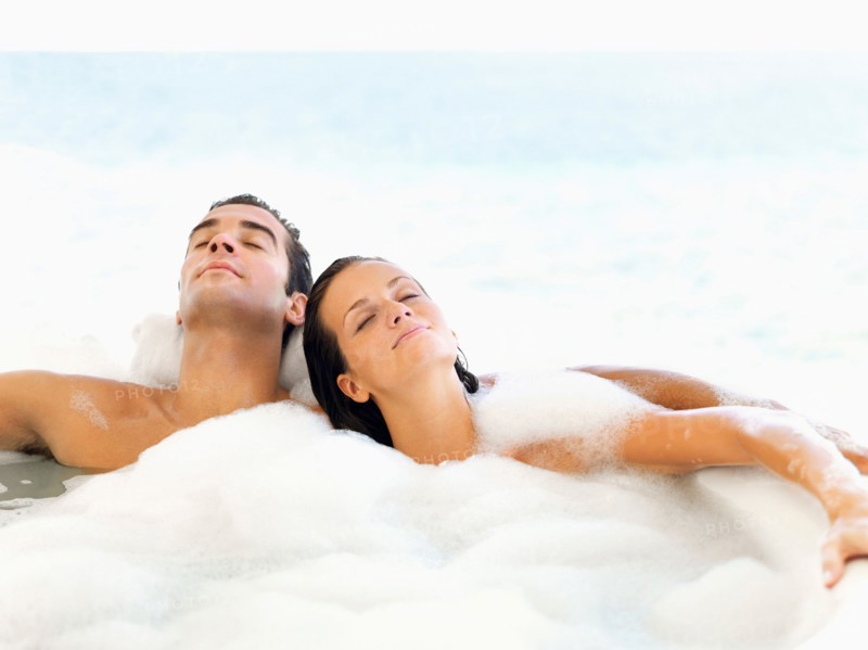 Couple relaxing in bathtub