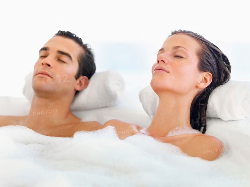 Couple relaxing in bathtub