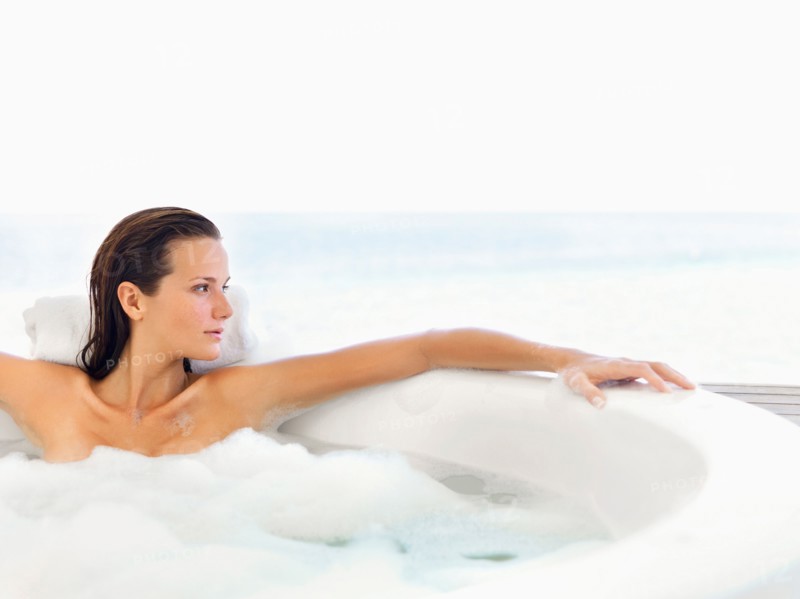 Woman relaxing in bathtub