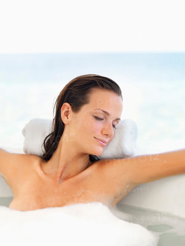 Woman relaxing in bathtub