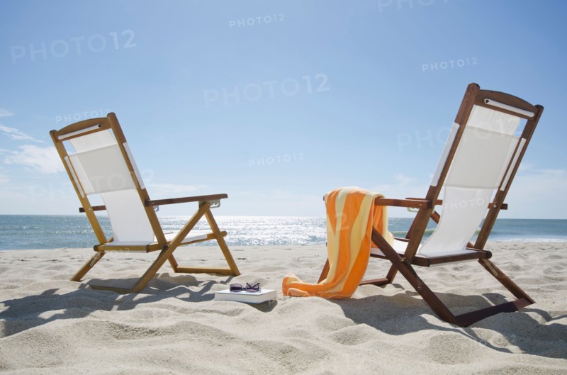 Sun chairs on sandy beach